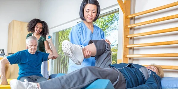 Image for a news release of an allied health professional helping someone stretch.
